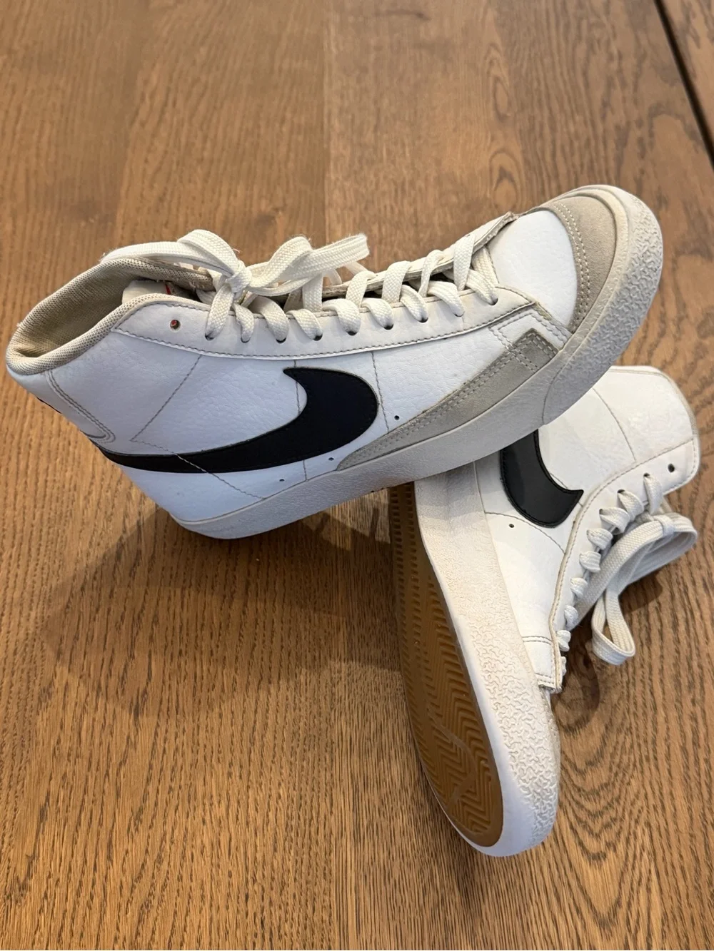 Nike White High-Top Sneakers with Black Swoosh